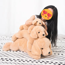 Load image into Gallery viewer, A person with long black hair and a heart-eyes emoji on their face is hugging a large stack of three golden retriever plush toys on a black and white patterned blanket.