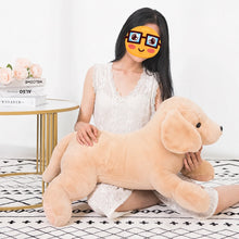 Load image into Gallery viewer, A woman sitting on a patterned rug holds a large plush golden retriever dog toy. She is wearing a white lace dress, and there is a small side table with books and flowers in the background.