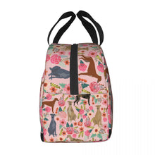 Load image into Gallery viewer, Side image of an insulated pink color Greyhound lunch bag with exterior pocket in bloom design