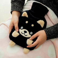 Load image into Gallery viewer, Black plush hot water bottle with Husky dog design held by a person on a pink blanket.