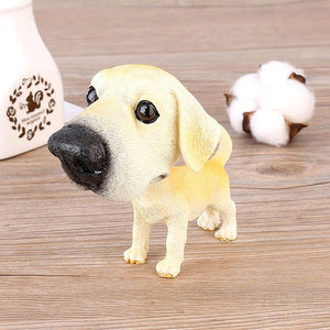 Image of a Labrador bobblehead standing on the floor