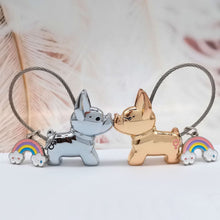Load image into Gallery viewer, Image of two metallic frenchie keychains in the color boy silver and girl light gold kissing each other