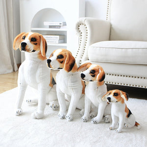 image of a woman playing with a collection of different sizes of  adorable beagle stuffed animal plush toys