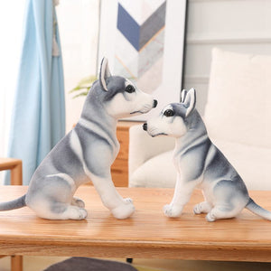 Image of two adorable Husky stuffed animal toys standing on a wooden table