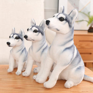 Image three cute Husky stuffed animal toys standing on a wooden table