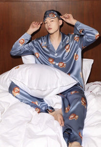Image of a girl sittiing on the bed wearing shiba inu pyjamas