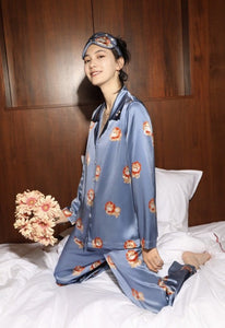 Image of a smiling girl sittiing on the bed wearing shiba inu pyjamas
