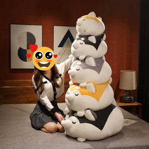 Image of a girl with her collection of husky stuffed animal huggable plush toy pillows in different sizes