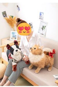 image of a woman playing with a pomeranian stuffed animal plush toy