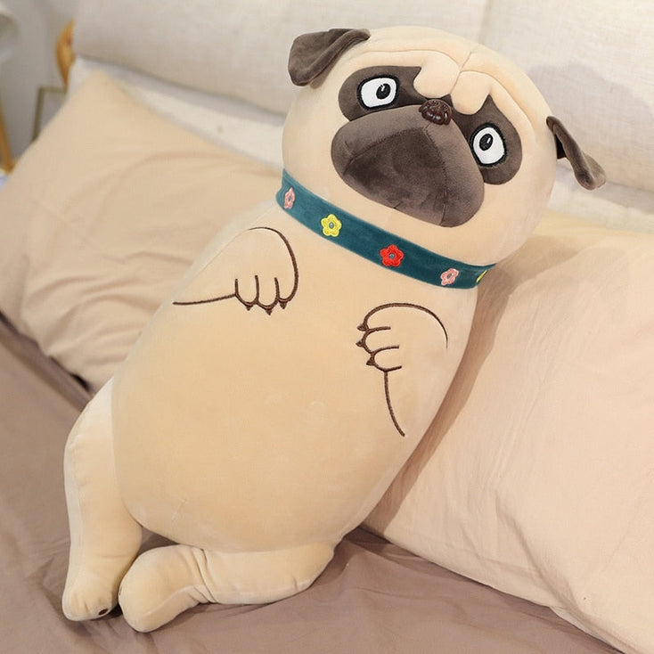 Image of a Pug plush toy pillow stuffed animal standing on the bed