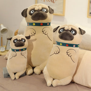 Image of three life size Pug stuffed animal plush toy pillows standing next to each other on the bed in different sizes