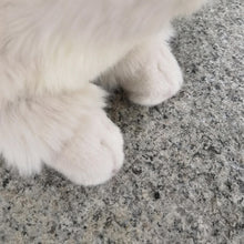 Load image into Gallery viewer, Close-up of soft, white plush Ragdoll cat paws with realistic fur texture resting on a grey stone surface.