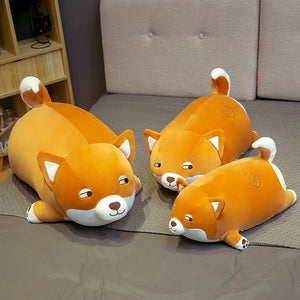 Image of three super cute Shiba stuffed animal plush toy pillows in small, medium, and large sizes kept on the bed
