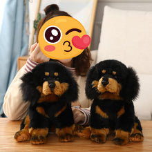 Load image into Gallery viewer, Two black and tan plush Tibetan mastiff dog toys sitting on a wooden table in front of a person whose face is covered by a winking emoji sticker.
