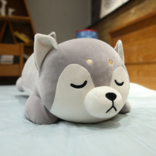 Load image into Gallery viewer, Front image of a sleeping giant Husky stuffed animal plush toy pillow kept on the bed