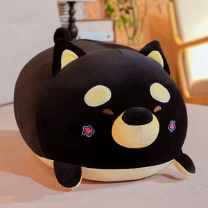 Image of a black color sleeping Shiba Inu stuffed animal plush toy pillow kept on the bed