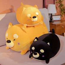 Load image into Gallery viewer, Image of three sleeping Shiba Inu stuffed animal plush toy pillows in the color orange and black in different sizes kept on the bed
