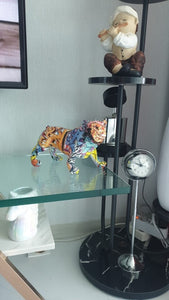 Image of a stunning multicolor English Bulldog statue kept on the cabinet glass