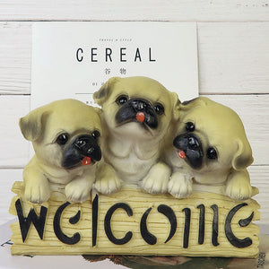 image of three pugs in a dog welcome staue