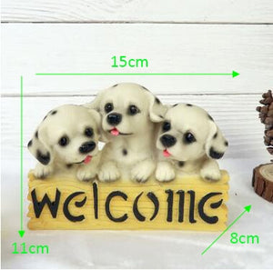 image of three dalmatians in a dog welcome staue