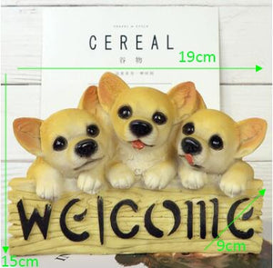 image of three chihuahuas in a dog welcome staue