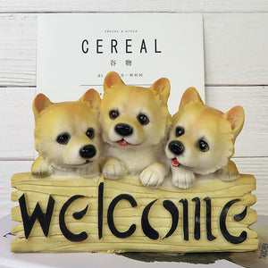 image of three shiba inus in a dog welcome staue
