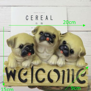 image of three dogs in a dog welcome staue