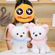 A girl playing with two white Chihuahua stuffed animal plush toys in small size