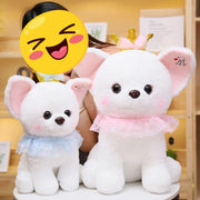 A girl playing with two white Chihuahua stuffed animal plush toys in different sizes