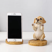 Load image into Gallery viewer, Image of a super cute yellow lab phone holder made of resin with an iphone placed on it