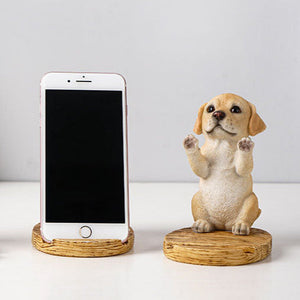 Image of a super cute yellow lab phone holder made of resin with an iphone placed on it