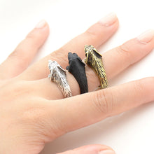 Load image into Gallery viewer, Image of three doxie wrap rings on the finger of a person in three colors including Antique Silver, Bronze, and Black Gunmetal