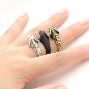 Image of three doxie wrap rings on the finger of a person in three colors including Antique Silver, Bronze, and Black Gunmetal