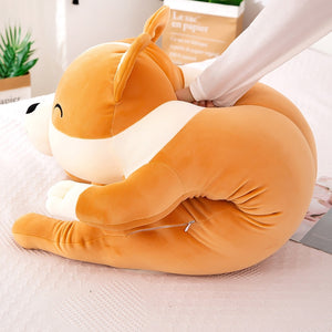 image of a woman playing with a corgi stuffed animal plush pillow