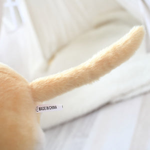 image of the tail of a yellow labrador stuffed animal plush toy