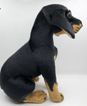 Load image into Gallery viewer, image of an adorable rottweiler stuffed animal plush toy on a table-sideview