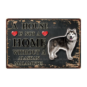 Image of an Alaskan Malamute Signboard with a text 'A House Is Not A Home Without A Alaskan Malamute' on a dark background