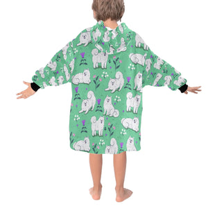 Image of a girl wearing an American Eskimo Dog blanket hoodie for kids in green color - Back View