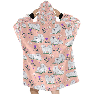 Image of a lady wearing an American Eskimo Dog blanket hoodie for women in peach color - Back View