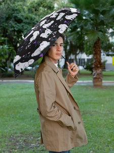 Image of a man walking with an American Eskimo Dog umbrella for men