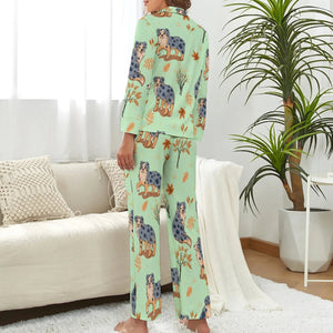image of a woman wearing a green pajamas set with autumn leaves design - back view