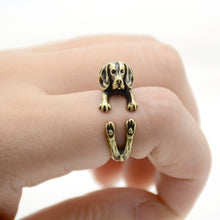 Load image into Gallery viewer, Front image of a finger wrap Beagle ring on the finger of a person in the color Antique Bronze