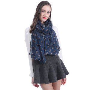 Image of a lady wearing an infinite print Beagle scarf in the navy blue color
