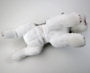 This image shows the cute belly side of a Belly Flop Schnauzer Stuffed Animal Plush Toy rolling on the floor.