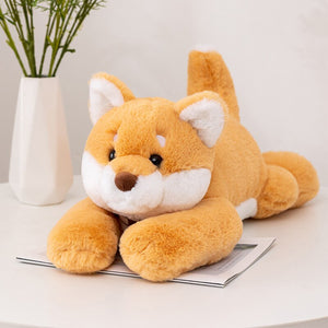 This image  shows an adorable Shiba Inu Stuffed Animal lying.