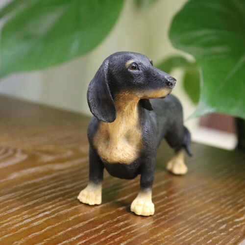 Black and brown dachshund figurine lying on a blue fringe rug realistic