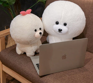 image of two bichon frise stuffed toys on a laptop
