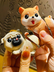 Image of a lady holding Pug and Corgi bobblehead in bobble-butt design