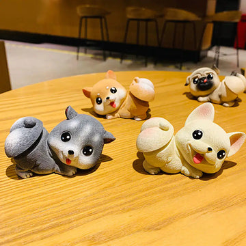 Image of four dog bobbleheads placed on the table in the the cutest bobble-butt design including Frenchie, Shiba Inu, Husky, and Pug boblehead