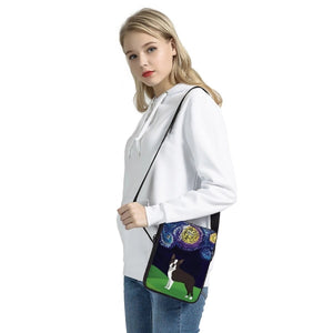 Image of a lady holding a boston terrier messenger bag